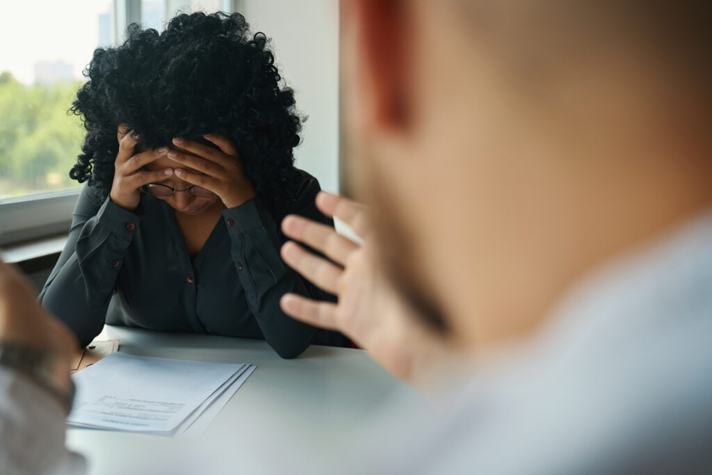 woman suffering from headache and holding her head