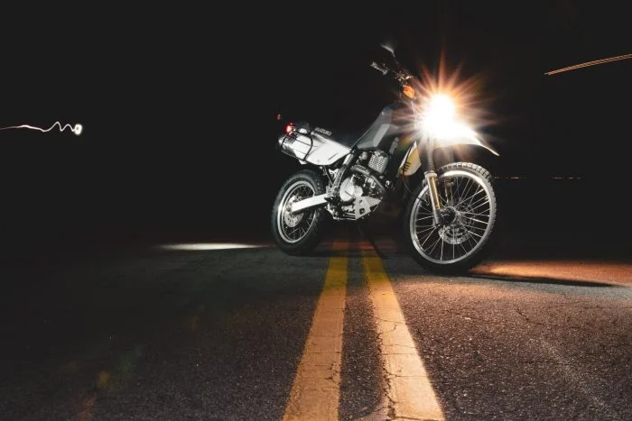 motorcycle in center of road at night