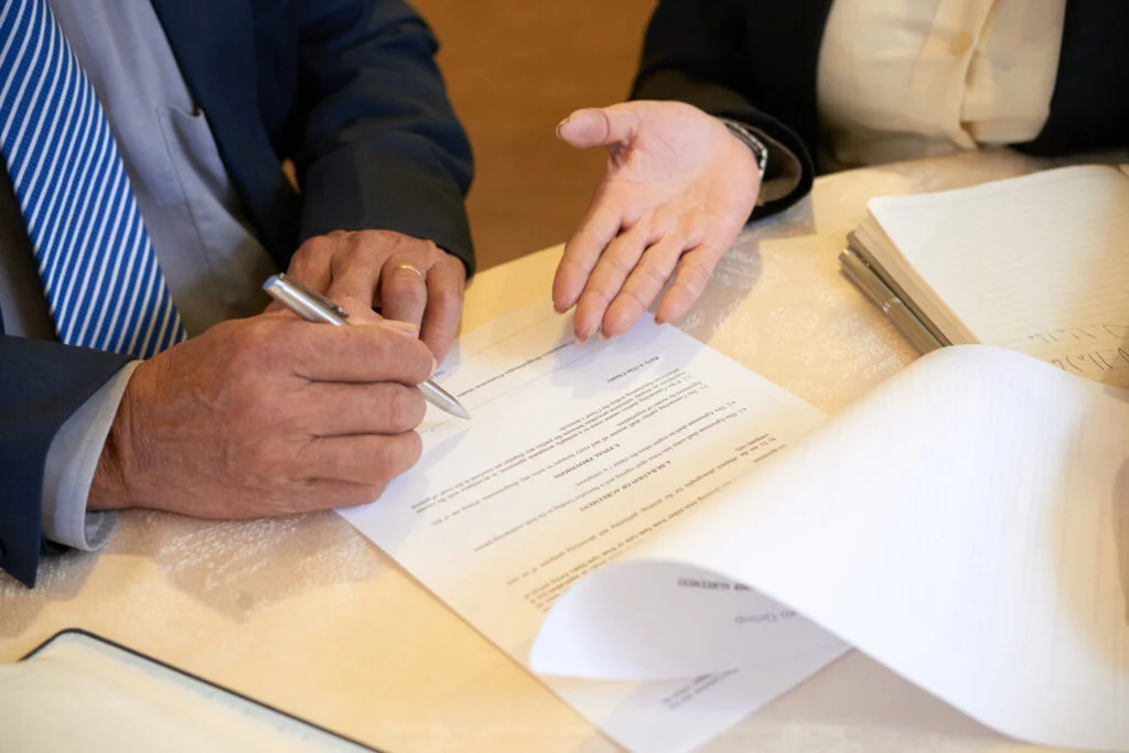 senior business people signing document