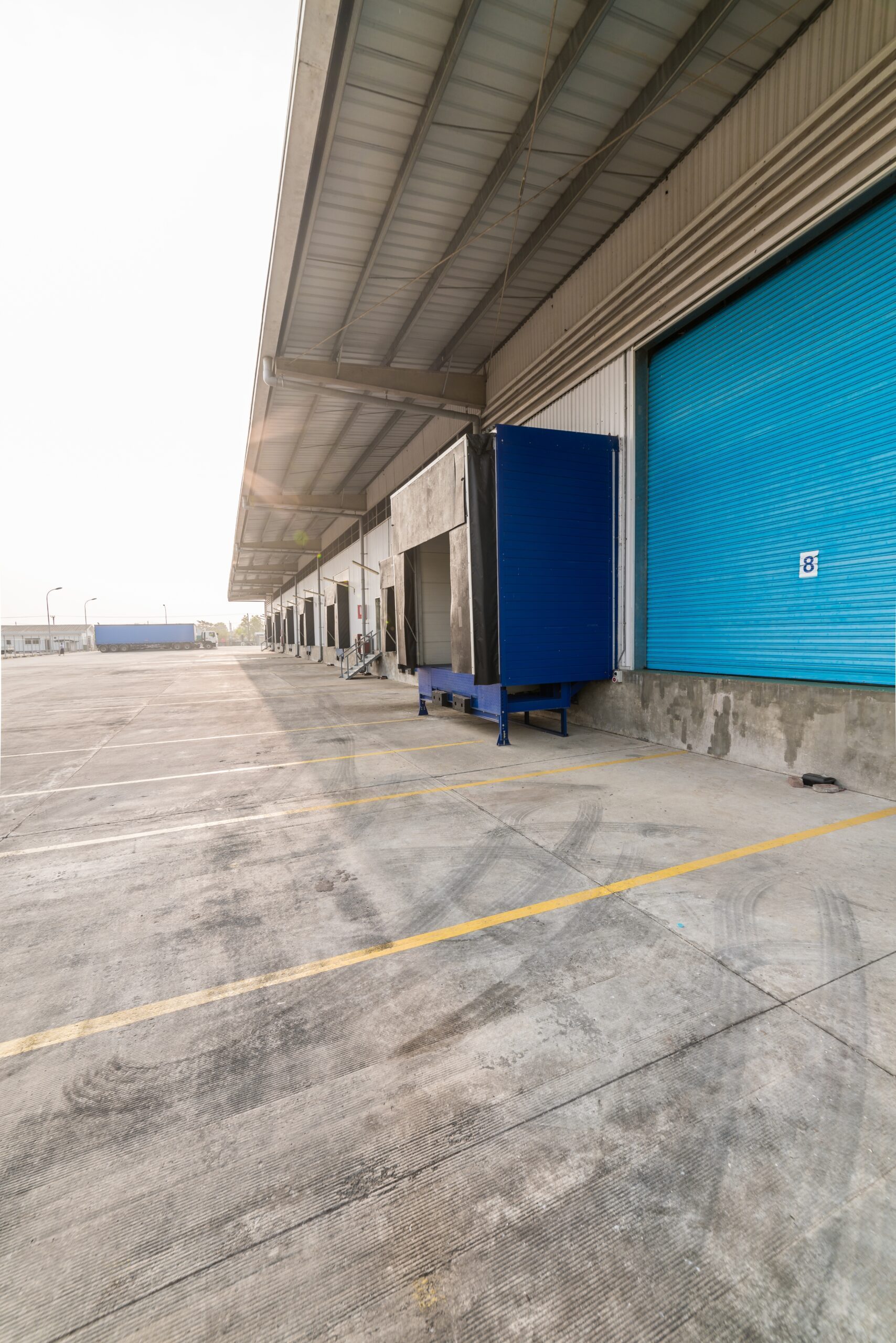 Wheel chocks and warning barrier illustrating California loading dock safety compliance