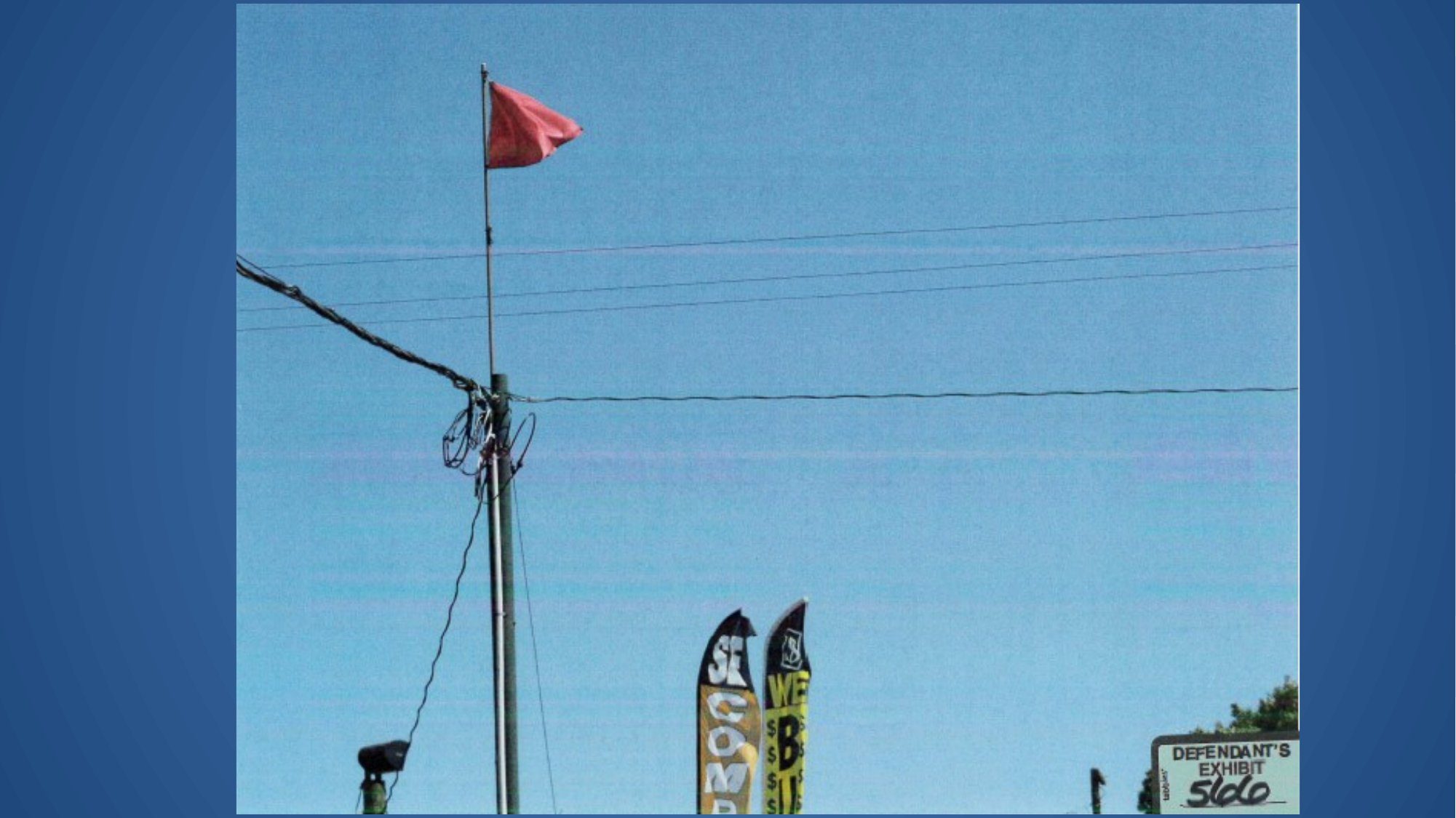 Electrocution premises liability case exhibit showing a vendor flag directly under an overhead power line at the swap meet